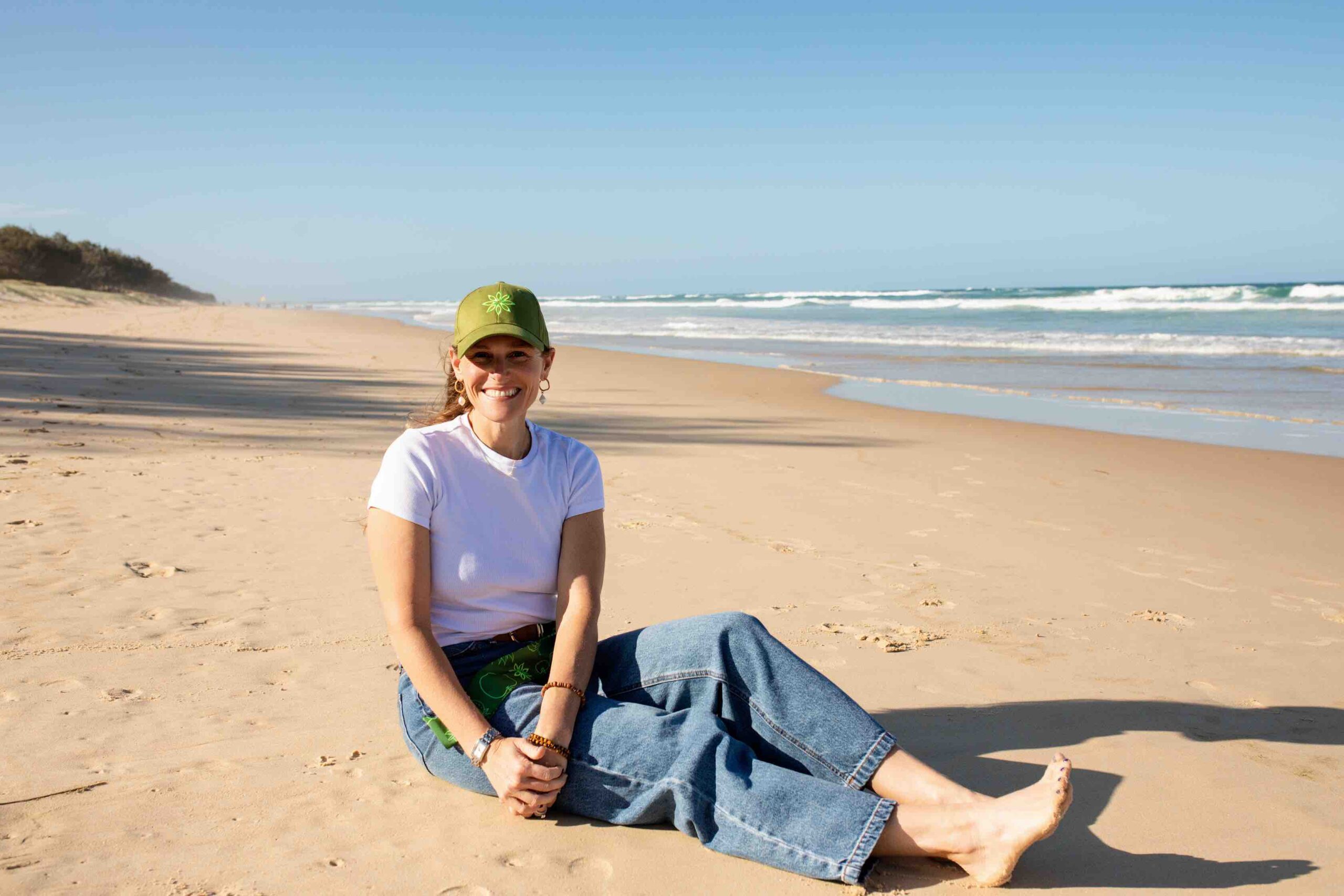 Dani in PurGreens hat at beach