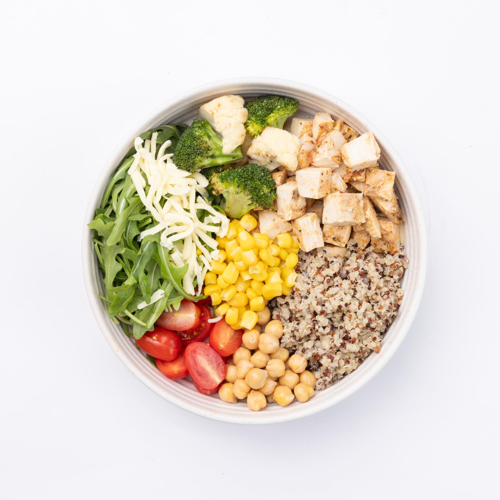 Quinoa Earth Bowl Arugula, quinoa, chicken, tomatoes, corn, chickpeas, broccoli, white cheddar, pesto dressing