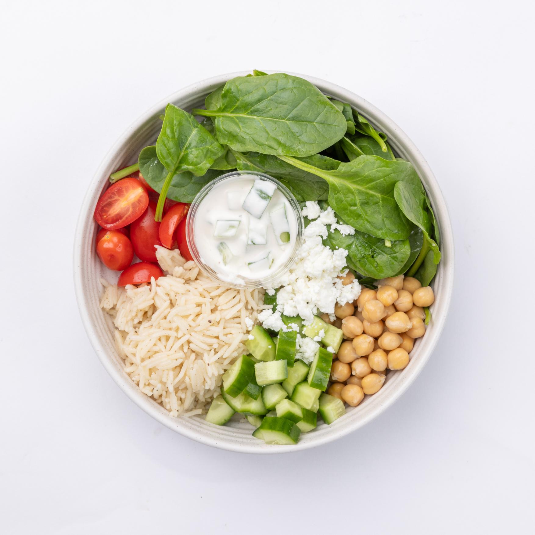 Mediterranean Bowl Spinach, wild rice, falafel, onions, tomatoes, chickpeas, feta, cucumbers, tzatziki