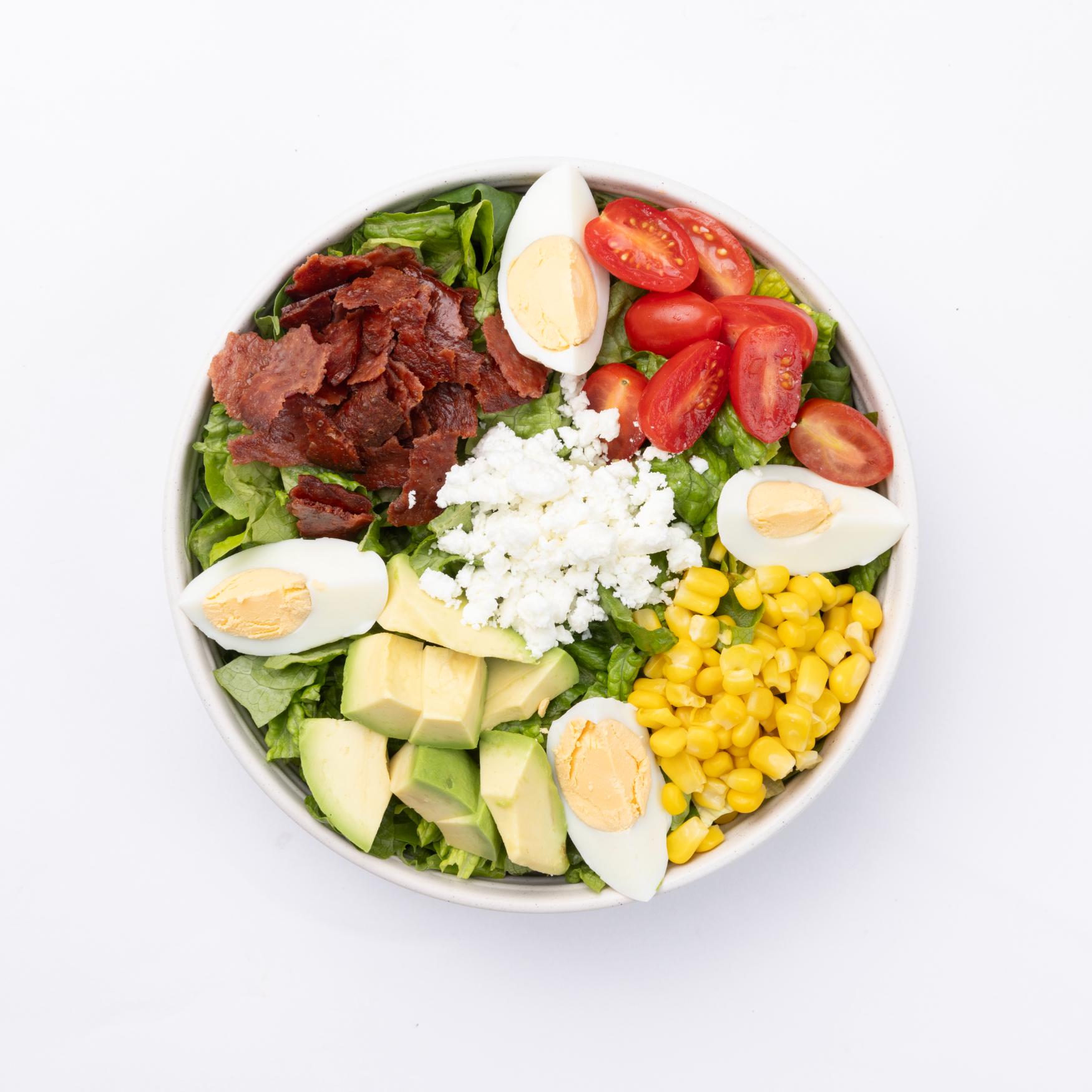 Cobb Romaine, mixed greens, avocado, turkey bacon, egg, corn, tomatoes, crumbled blue cheese, lime cilantro jalapeno vinaigrette