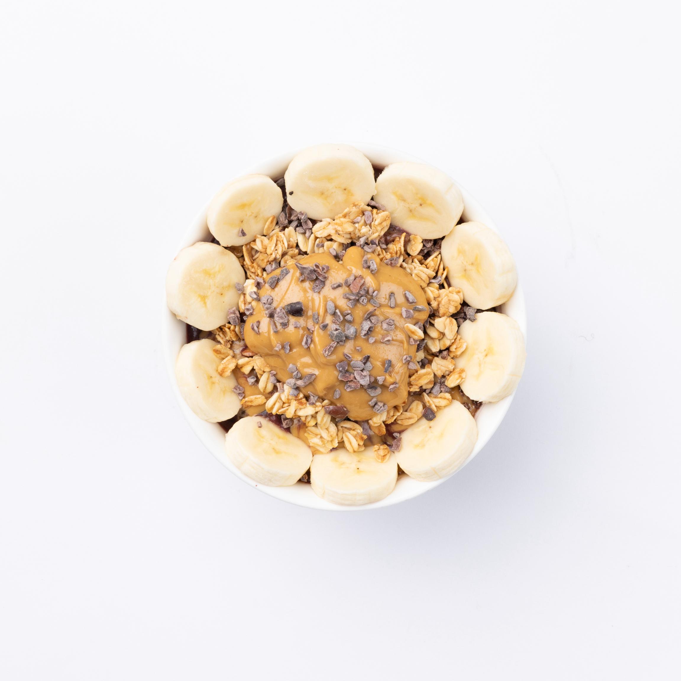 Banana Nut Acai, coconut water, banana, chocolate protein topped with granola, sliced banana, almond butter, cacao nibs and honey